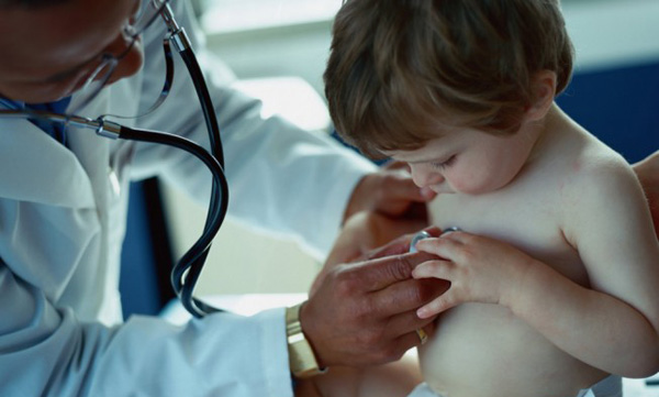Doctor treating young child